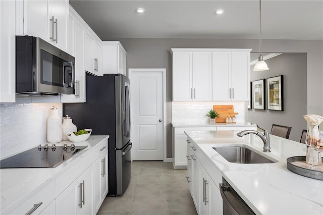 10816 SW 72nd Cir, Ocala, FL 34476 - kitchen featuring appliances with stainless steel finishes, white cabinetry, decorative backsplash, light stone counters, and recessed lighting