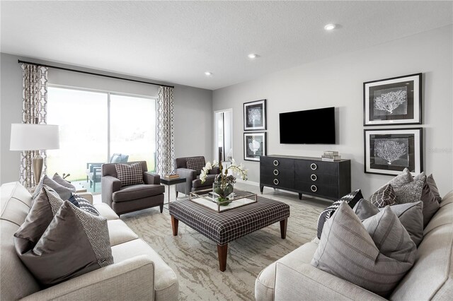 10919 SW 73rd Ct, Ocala, FL 34476 - living room with recessed lighting, light wood-type flooring, and a textured ceiling