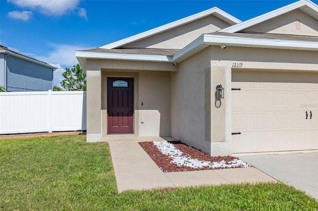 12119 Barnsley Reserve Pl, Gibsonton, FL 33534 - view of exterior entry featuring stucco siding and a garage