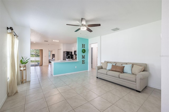 12119 Barnsley Reserve Pl, Gibsonton, FL 33534 - living area with light tile patterned floors and a ceiling fan
