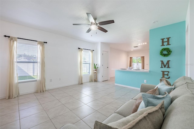 12119 Barnsley Reserve Pl, Gibsonton, FL 33534 - living area with ceiling fan and light tile patterned floors