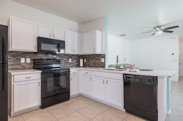 12119 Barnsley Reserve Pl, Gibsonton, FL 33534 - kitchen featuring black appliances, a peninsula, light countertops, tasteful backsplash, and light tile patterned floors