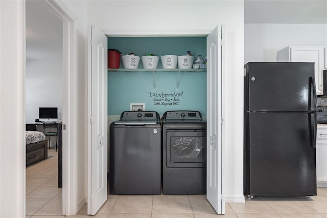 12119 Barnsley Reserve Pl, Gibsonton, FL 33534 - laundry area featuring washing machine and clothes dryer and light tile patterned floors