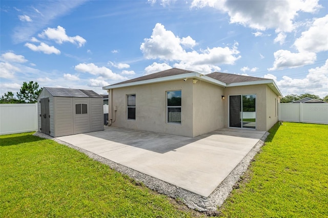 12119 Barnsley Reserve Pl, Gibsonton, FL 33534 - back of house featuring stucco siding, a storage shed, and a patio area