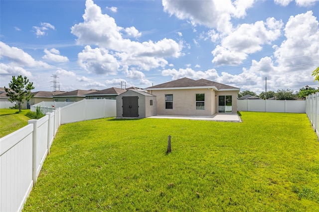 12119 Barnsley Reserve Pl, Gibsonton, FL 33534 - rear view of property with a storage shed, a patio, a fenced backyard, and stucco siding