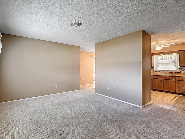 11094 Auburndale St, Spring Hill, FL 34609 - spare room with a textured ceiling, a ceiling fan, and light colored carpet