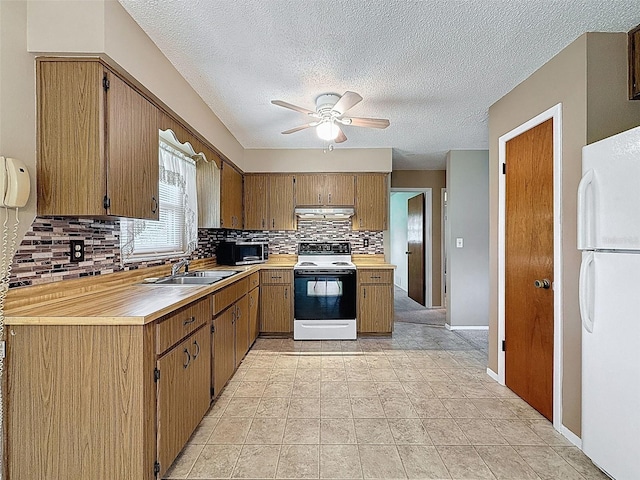 11094 Auburndale St, Spring Hill, FL 34609 - kitchen with white appliances, under cabinet range hood, tasteful backsplash, ceiling fan, and light countertops