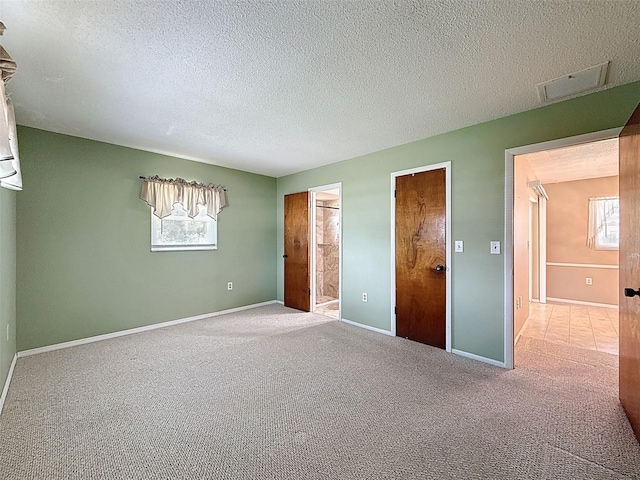 11094 Auburndale St, Spring Hill, FL 34609 - unfurnished bedroom featuring carpet, a textured ceiling, and connected bathroom