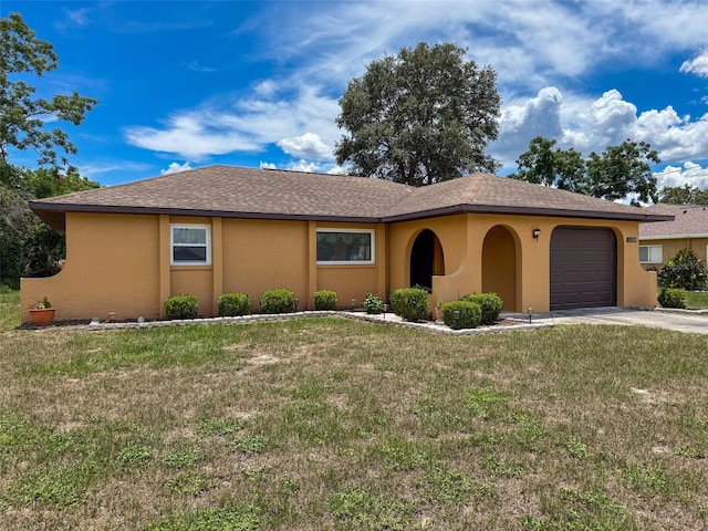 11094 Auburndale St, Spring Hill, FL 34609 - view of front of home with stucco siding, an attached garage, a front lawn, and concrete driveway