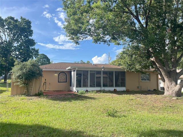 10458 Clingman St, Spring Hill, FL 34608 - rear view of property with a sunroom, stucco siding, and roof with shingles
