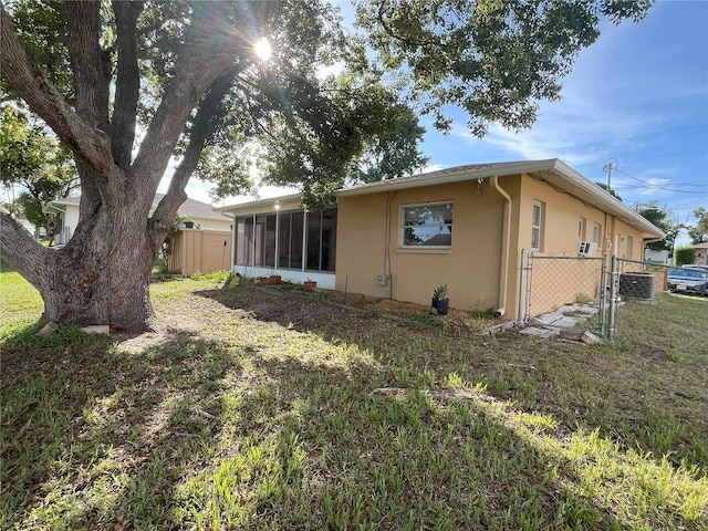 10458 Clingman St, Spring Hill, FL 34608 - back of property featuring stucco siding, a sunroom, and a gate