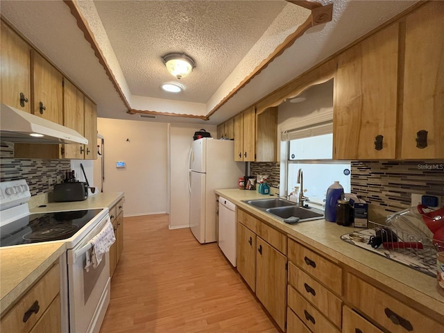 10458 Clingman St, Spring Hill, FL 34608 - kitchen with white appliances, a textured ceiling, tasteful backsplash, light countertops, and a raised ceiling