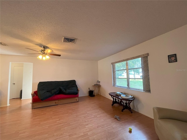 10458 Clingman St, Spring Hill, FL 34608 - sitting room with wood finished floors, a ceiling fan, and a textured ceiling