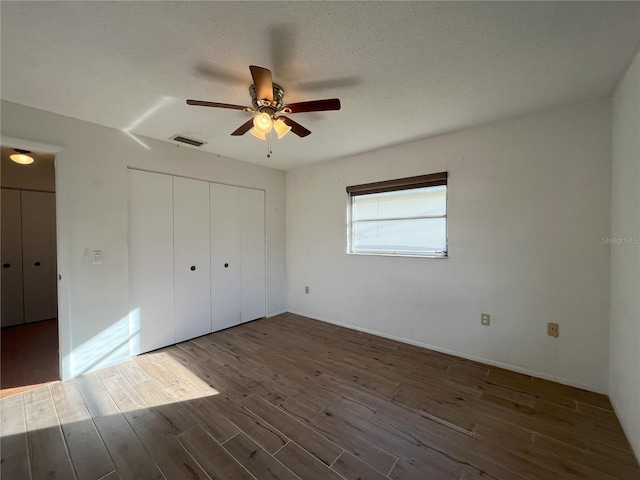 10458 Clingman St, Spring Hill, FL 34608 - unfurnished bedroom featuring wood finished floors, a closet, and a ceiling fan