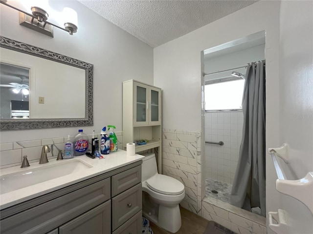 10458 Clingman St, Spring Hill, FL 34608 - bathroom featuring vanity, a stall shower, tile walls, a textured ceiling, and ceiling fan