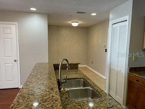 700 S Harbour Island Blvd Unit 407, Tampa, FL 33602 - kitchen featuring stone countertops, brown cabinets, and recessed lighting