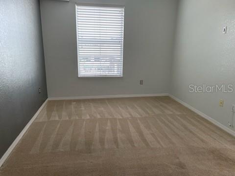 700 S Harbour Island Blvd Unit 407, Tampa, FL 33602 - spare room featuring light carpet and baseboards