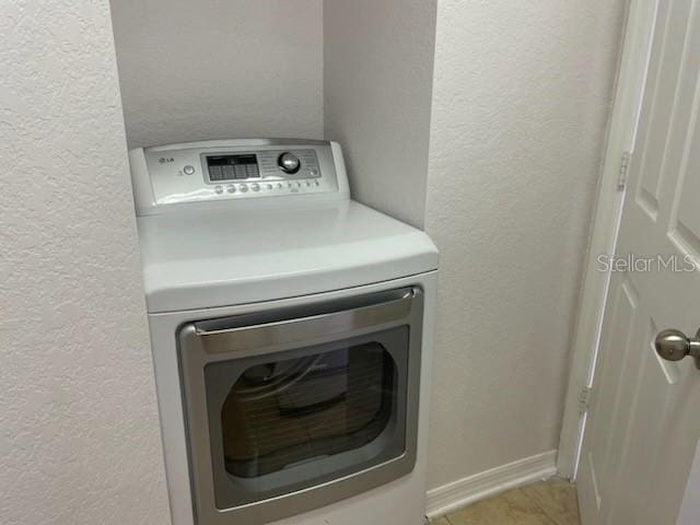 700 S Harbour Island Blvd Unit 407, Tampa, FL 33602 - laundry room with washer / clothes dryer and a textured wall