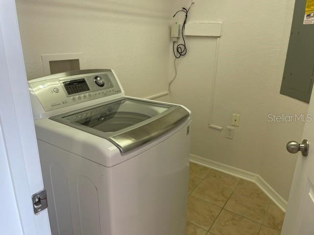 700 S Harbour Island Blvd Unit 407, Tampa, FL 33602 - laundry room featuring washer / dryer, electric panel, and light tile patterned floors