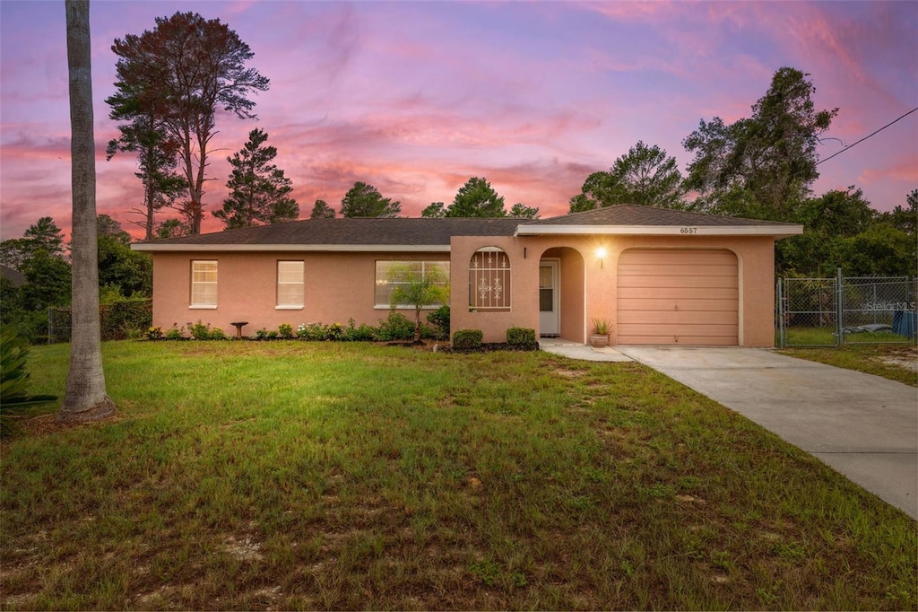 6557 Landover Blvd, Spring Hill, FL 34608 - single story home featuring driveway, an attached garage, and stucco siding