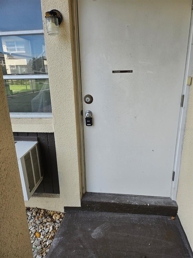 4743 Jasper Dr Unit 107, New Port Richey, FL 34652 - doorway to property with stucco siding