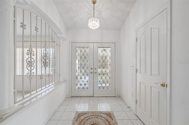 10394 Ireland St, Spring Hill, FL 34608 - foyer entrance with french doors and a chandelier