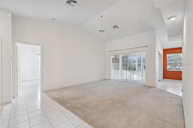 10394 Ireland St, Spring Hill, FL 34608 - spare room with light carpet, light tile patterned flooring, a ceiling fan, and high vaulted ceiling