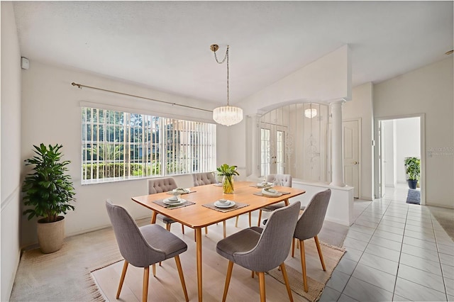 10394 Ireland St, Spring Hill, FL 34608 - dining room with decorative columns, healthy amount of natural light, arched walkways, lofted ceiling, and a chandelier