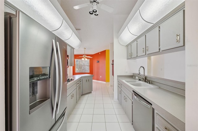 10394 Ireland St, Spring Hill, FL 34608 - kitchen featuring appliances with stainless steel finishes, ceiling fan, light tile patterned floors, and light countertops
