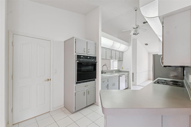 10394 Ireland St, Spring Hill, FL 34608 - kitchen with black oven, dishwasher, a ceiling fan, a peninsula, and light countertops