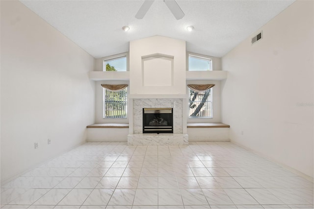 10394 Ireland St, Spring Hill, FL 34608 - unfurnished living room with a high end fireplace, ceiling fan, and high vaulted ceiling