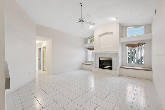 10394 Ireland St, Spring Hill, FL 34608 - unfurnished living room with lofted ceiling, a ceiling fan, a high end fireplace, and light tile patterned flooring