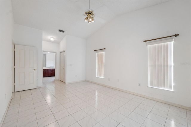 10394 Ireland St, Spring Hill, FL 34608 - unfurnished room featuring vaulted ceiling, light tile patterned flooring, and a ceiling fan
