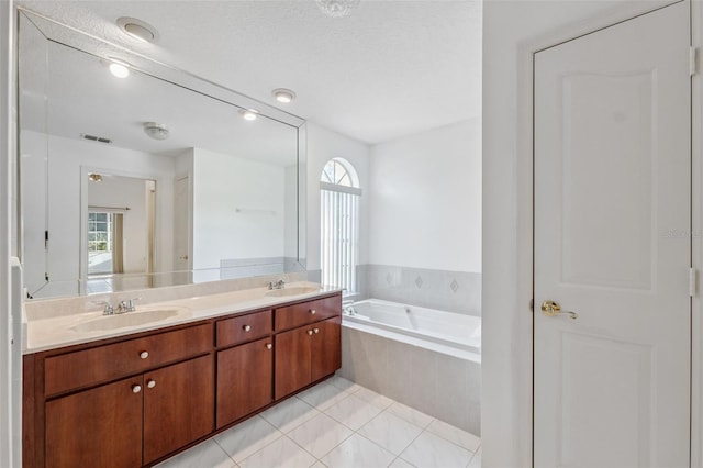 10394 Ireland St, Spring Hill, FL 34608 - full bath featuring plenty of natural light, a garden tub, double vanity, and tile patterned floors