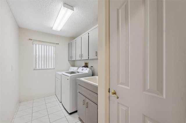 10394 Ireland St, Spring Hill, FL 34608 - laundry area featuring washer and clothes dryer, cabinet space, and a textured ceiling