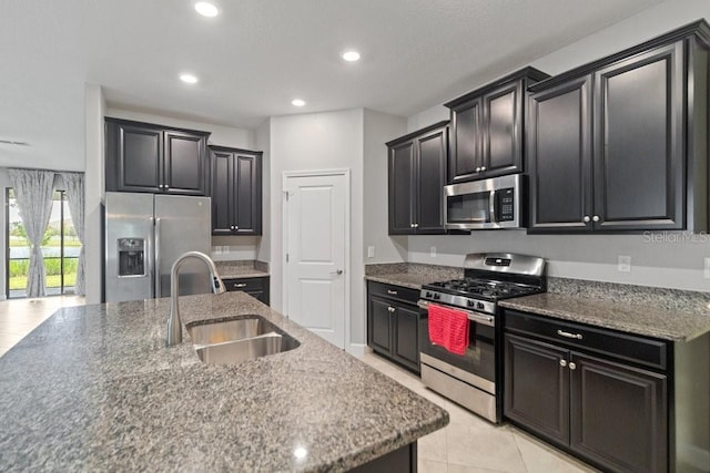 16874 Balance Cv, Land O Lakes, FL 34638 - kitchen featuring stainless steel appliances, dark cabinets, recessed lighting, and light tile patterned floors