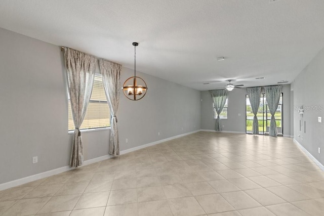 16874 Balance Cv, Land O Lakes, FL 34638 - unfurnished room featuring a chandelier, a ceiling fan, light tile patterned flooring, and a textured ceiling
