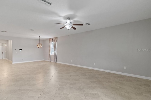 16874 Balance Cv, Land O Lakes, FL 34638 - empty room featuring a ceiling fan, a chandelier, and light tile patterned flooring