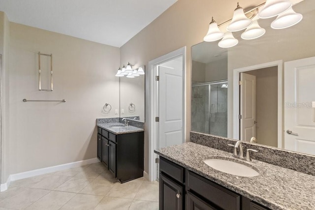 16874 Balance Cv, Land O Lakes, FL 34638 - bathroom featuring a stall shower, two vanities, and tile patterned floors