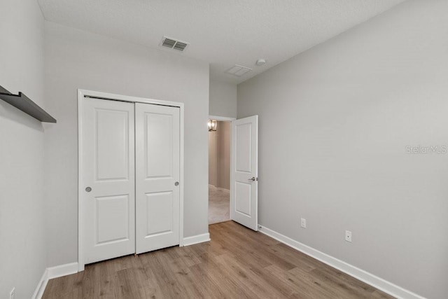 16874 Balance Cv, Land O Lakes, FL 34638 - unfurnished bedroom with light wood-style flooring and a closet