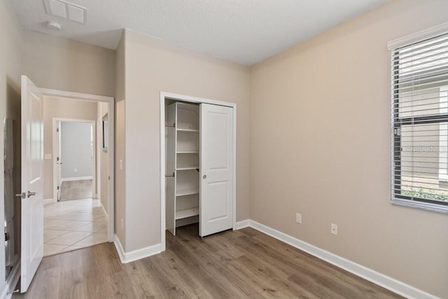 16874 Balance Cv, Land O Lakes, FL 34638 - unfurnished bedroom featuring wood finished floors and a closet