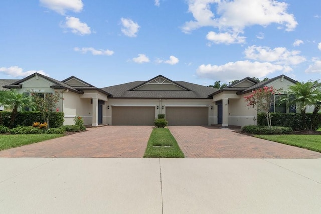 16874 Balance Cv, Land O Lakes, FL 34638 - ranch-style house featuring decorative driveway, an attached garage, stucco siding, and roof with shingles