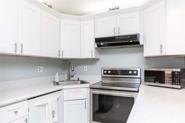 3153 Lake Pine Way Unit A1, Tarpon Springs, FL 34688 - kitchen with appliances with stainless steel finishes, under cabinet range hood, light countertops, and white cabinets
