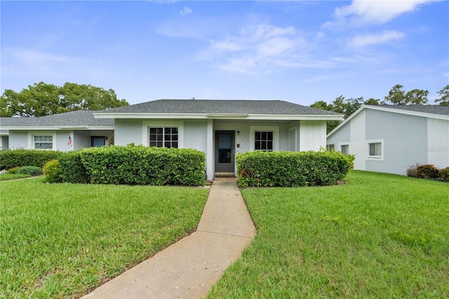 7700 Danube Dr Unit 7700, Hudson, FL 34667 - view of front facade featuring a front lawn and a shingled roof