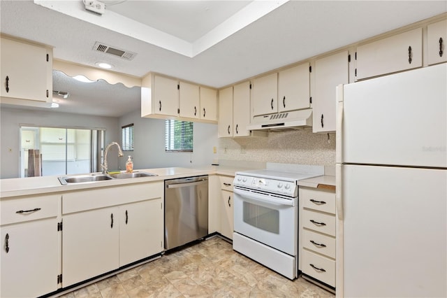 7700 Danube Dr Unit 7700, Hudson, FL 34667 - kitchen featuring white appliances, under cabinet range hood, light countertops, and decorative backsplash