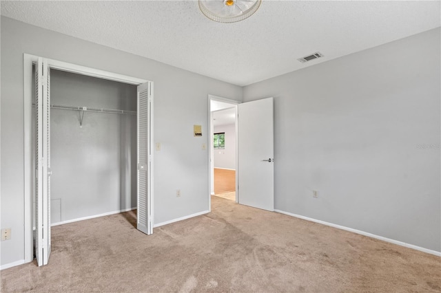7700 Danube Dr Unit 7700, Hudson, FL 34667 - unfurnished bedroom featuring carpet floors, a closet, and a textured ceiling