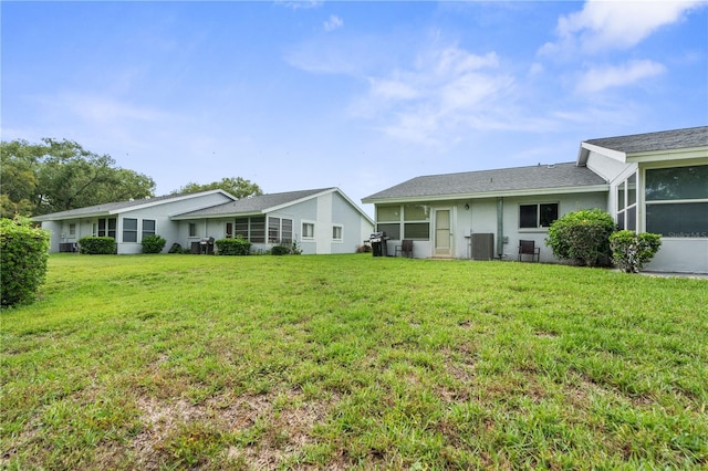 7700 Danube Dr Unit 7700, Hudson, FL 34667 - back of property with a lawn, stucco siding, and a sunroom