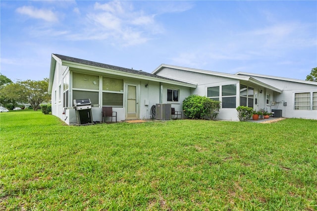 7700 Danube Dr Unit 7700, Hudson, FL 34667 - rear view of property featuring stucco siding and a lawn