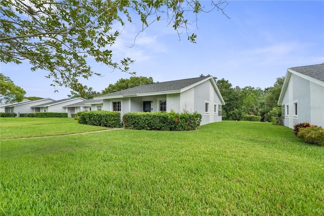 7700 Danube Dr Unit 7700, Hudson, FL 34667 - view of home's exterior featuring a yard and stucco siding
