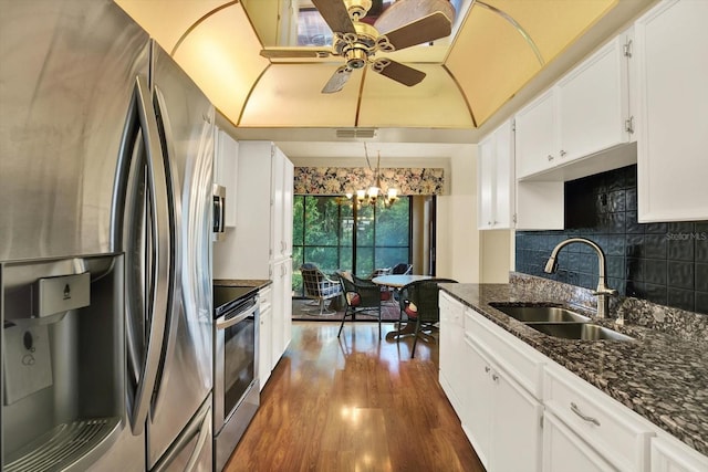 6654 Brambleleaf Dr, Spring Hill, FL 34606 - kitchen with stainless steel appliances, white cabinetry, dark wood-style floors, ceiling fan, and dark stone countertops